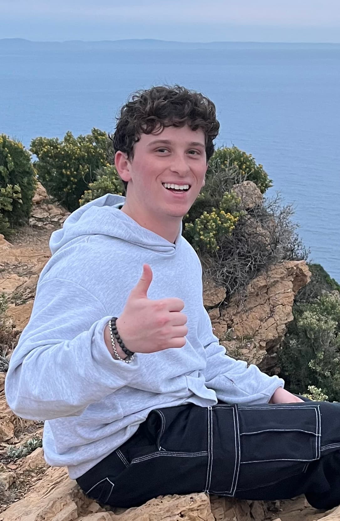 Jason Rosenberg smiling beside the ocean
